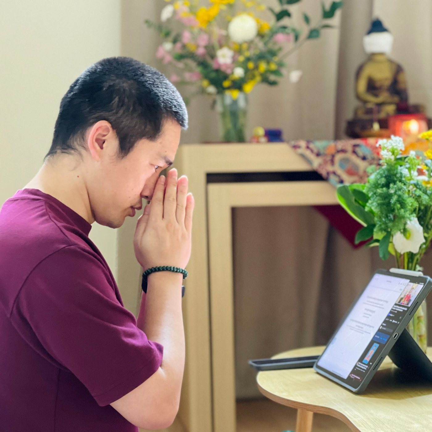 GarTul Chimi Dorjee Rinpoche with palms joined in the shrine room of Oseling